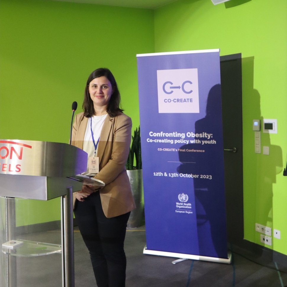 Ioana Vlad was one of the speakers during the Conference. Here she is smiling at the podium after her talk.