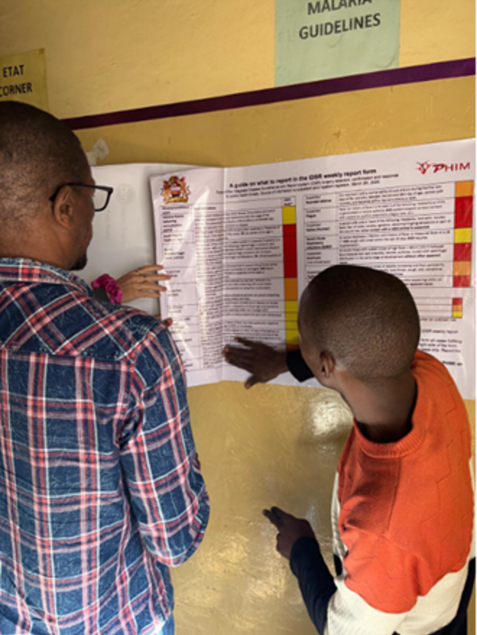 Two men hanging up a poster. Picture