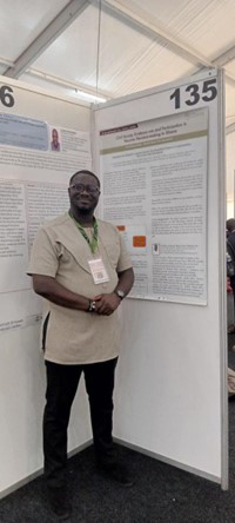 Daniel Nana in front of his poster. Picture