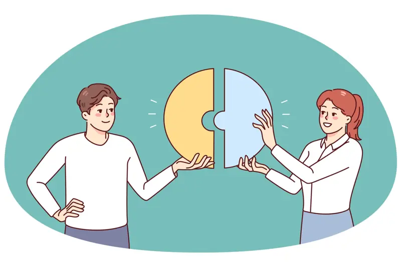 to mennesker som holder to puslespillbiter mot hverandre