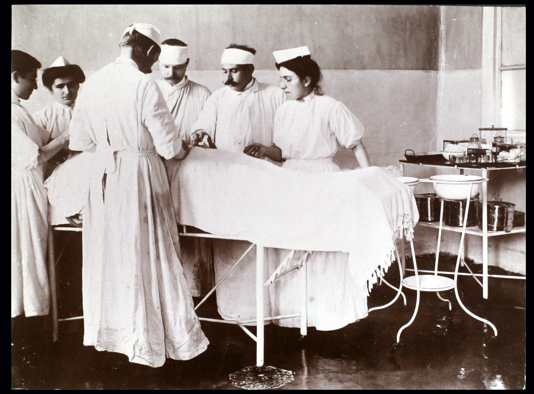 Doctors and nurses gathered around a patient..jpg