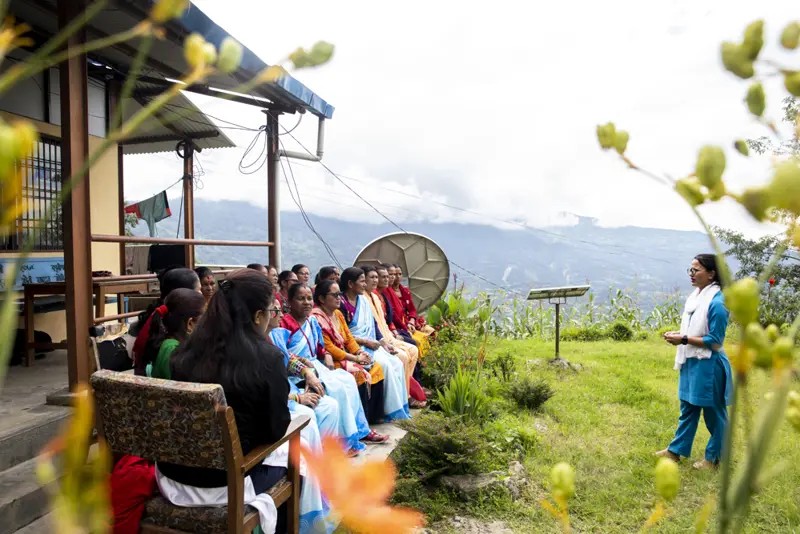 One person speaking in front of group of women in Nepal